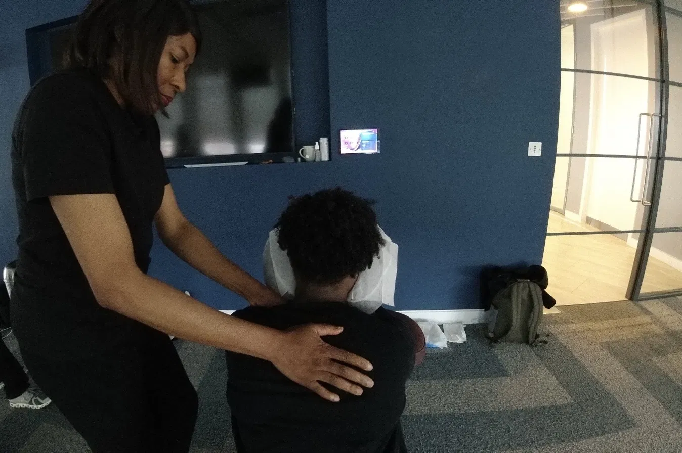 Corporate onsite chair massage in an office breakout space